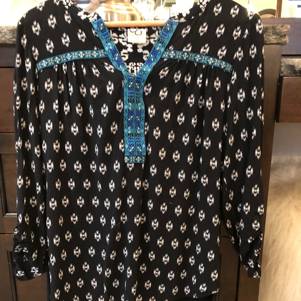 A Black blouse with a White pattern on top